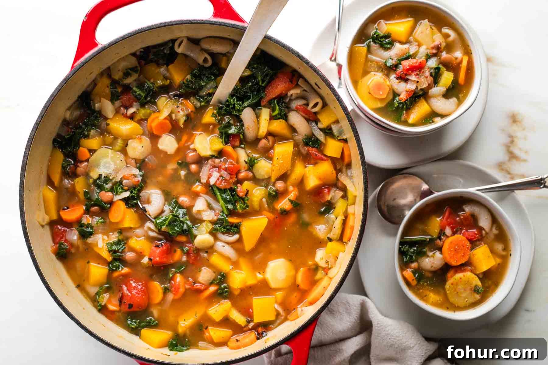 Vegan Fall Minestrone Soup with Roasted Autumn Vegetables 13 Ladling chunky minestrone soup from a dutch oven into bowls.