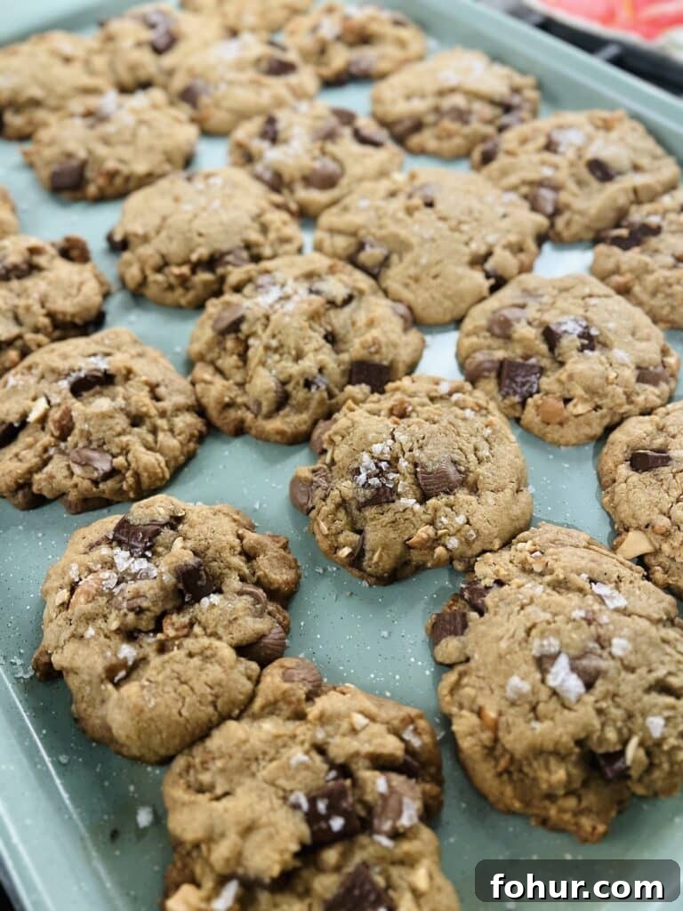 Chocolate Chip Cookies with Peanut Butter Cups, Sea Salt and Nuts 6 Just baked Salted Peanut Butter Cup Chocolate Chip Cookies on sheet pan.