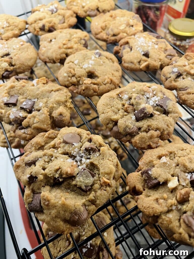 Chocolate Chip Cookies with Peanut Butter Cups, Sea Salt and Nuts 7 Salted Peanut Butter Cup Chocolate Chip Cookies cooling on wire rack.