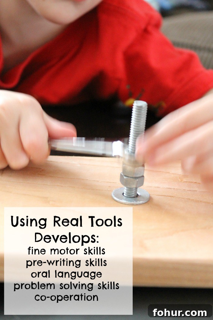 child with a red shirt using a wrench on nuts and bolts on a piece of wood.