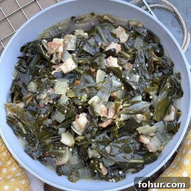 Creamy Southern Broccoli Casserole Recipe 11 A bowl of southern collard greens on a metal rack with a yellow towel.