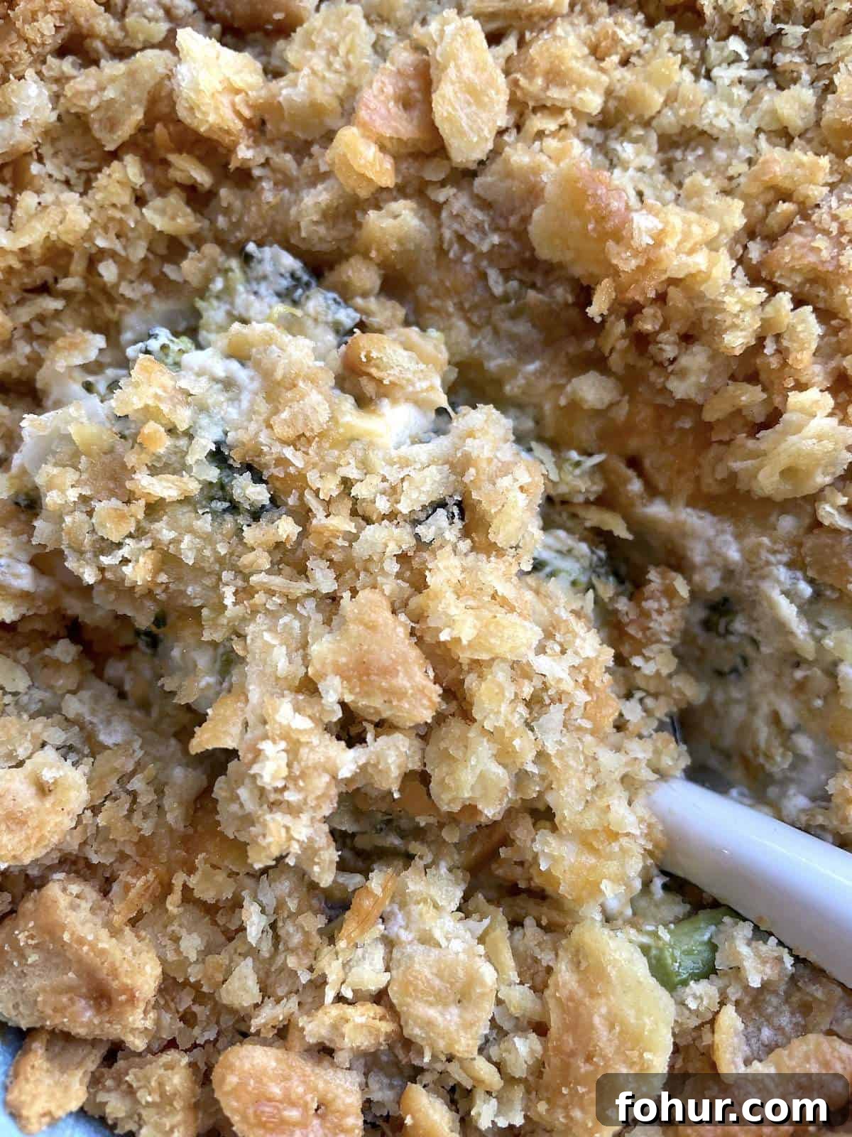 Creamy Southern Broccoli Casserole Recipe 14 A big scoop of broccoli casserole covered in buttery crackers.