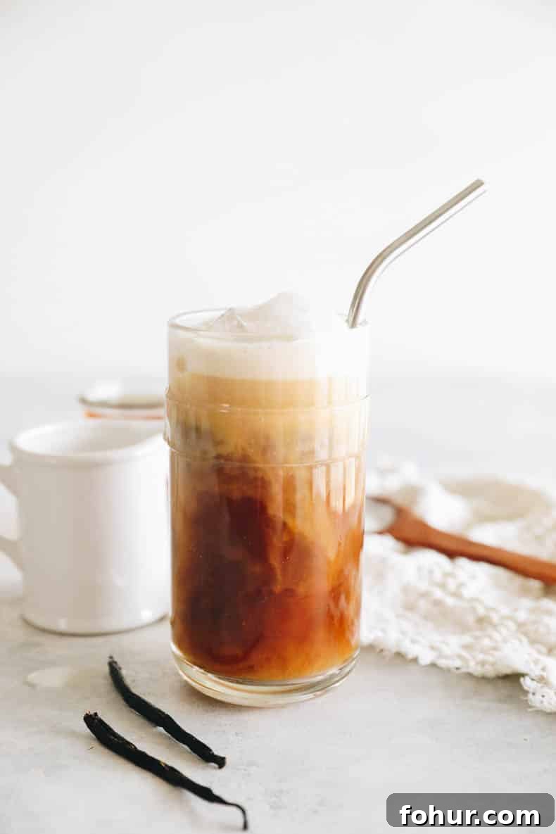 cold brew coffee in a glass cup topped with vanilla sweet cream.