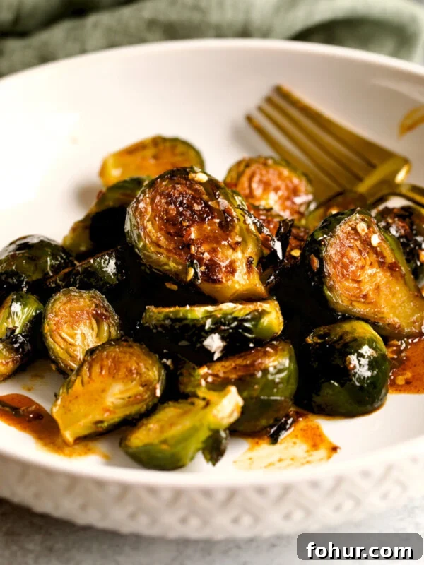 Oven Baked Italian Sausage Recipe with Peppers and Onions 12 Longhorn Steakhouse Crispy Brussels Sprouts Recipe on plate.