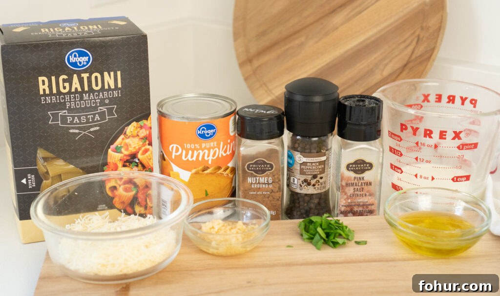 Creamy Pumpkin Pasta with Sage and Parmesan 3 pumpkin pasta ingredients on counter with cutting board