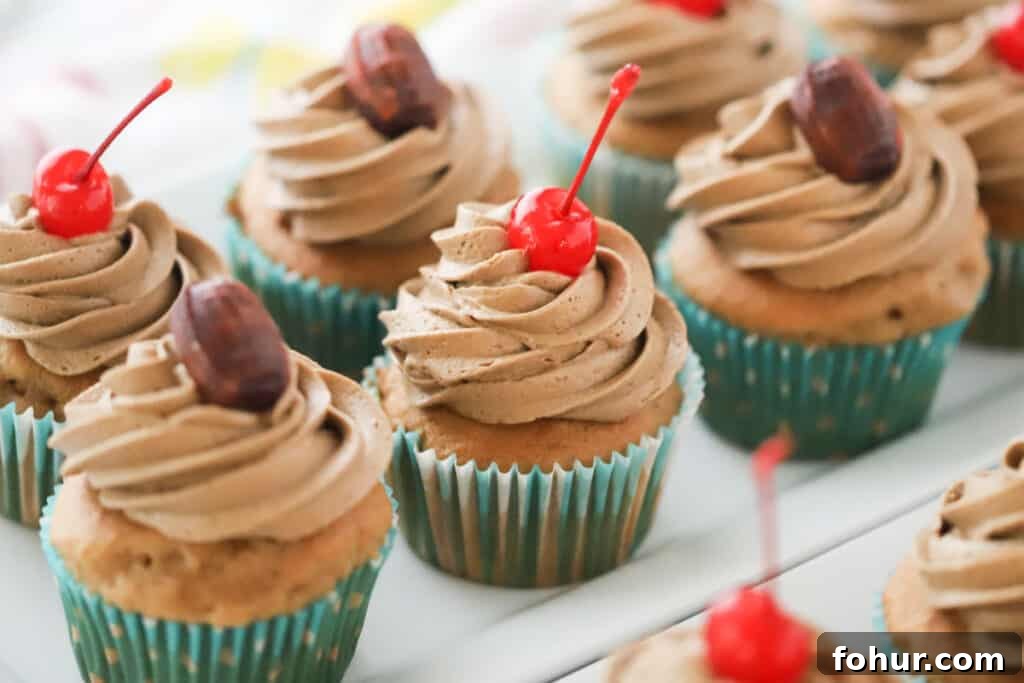 Root Beer Float Cupcakes with Vanilla Cream Frosting 4 Delicious root beer cupcakes, topped with piped root beer frosting and maraschino cherries.