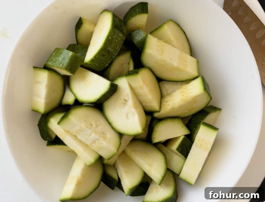 Crispy Air Fryer Zucchini Recipe 6 zucchini cut up in a bowl step 3