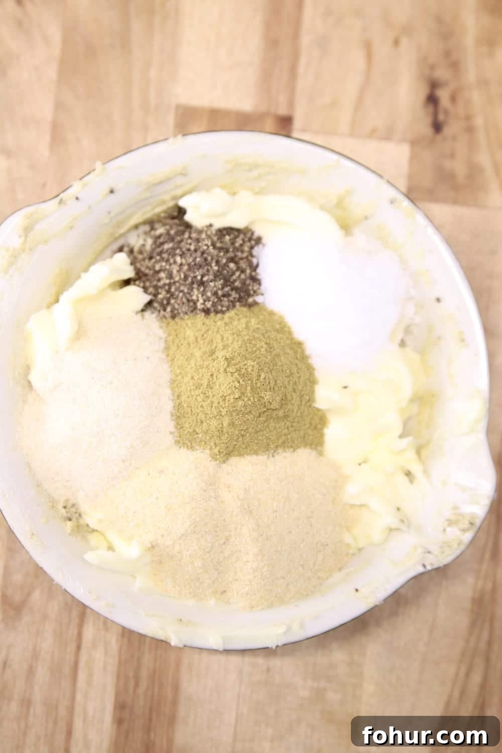 bowl with softened butter and seasonings