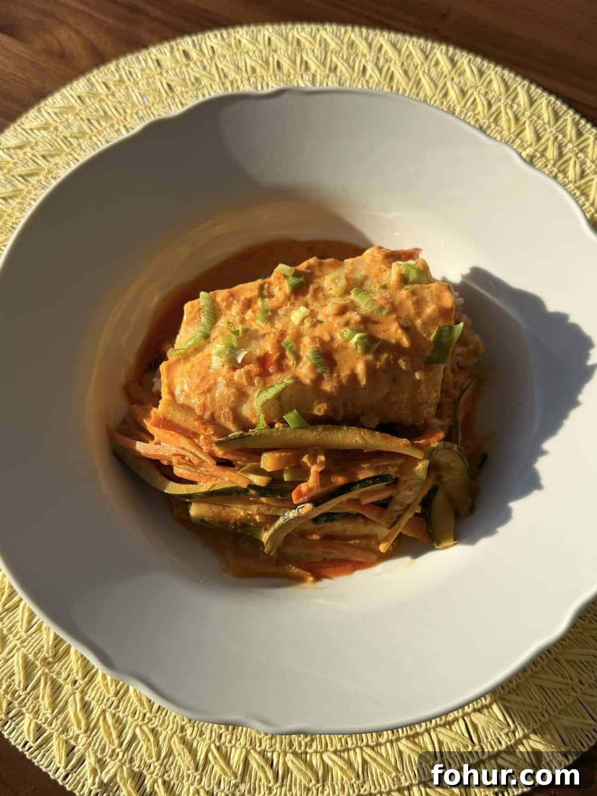 Cod in Thai Red Coconut Curry 2 Bowl of red coconut curry cod with rice and scallions