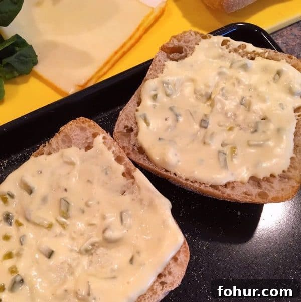 Crispy Fried Fish Sandwich Recipe with Tartar Sauce 5 Homemade tarter sauce spread on top of Ciabatta rolls