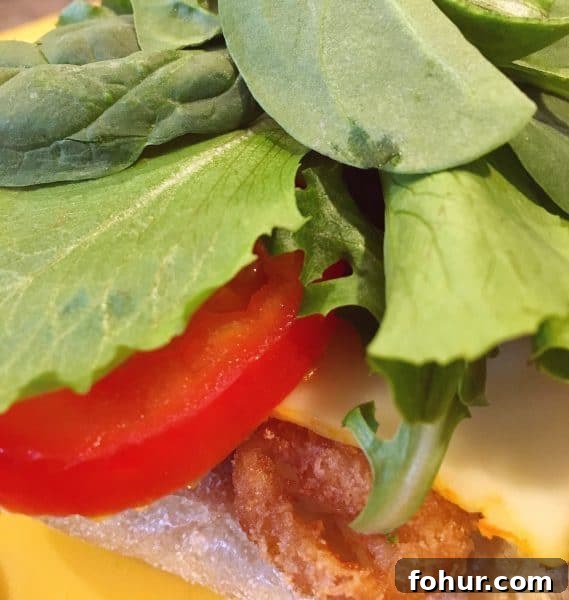 Crispy Fried Fish Sandwich Recipe with Tartar Sauce 8 Spring Mix on top of tomatoes
