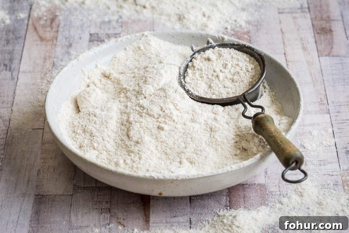 How to Bake with Gluten-Free Flours: Tips and Techniques 3 Sorghum Flour in a white bowl showing light and fluffy texture.