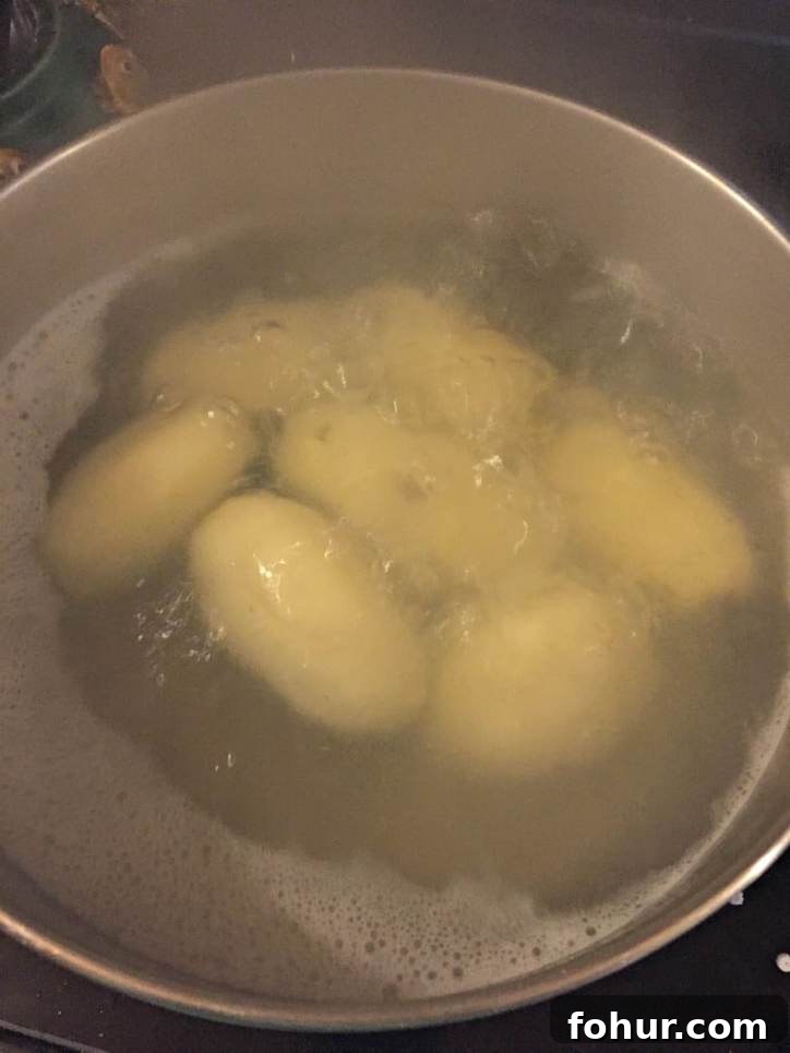 How to Make Homemade Chicken Stock from Scratch 4 Potatoes simmering in a stockpot