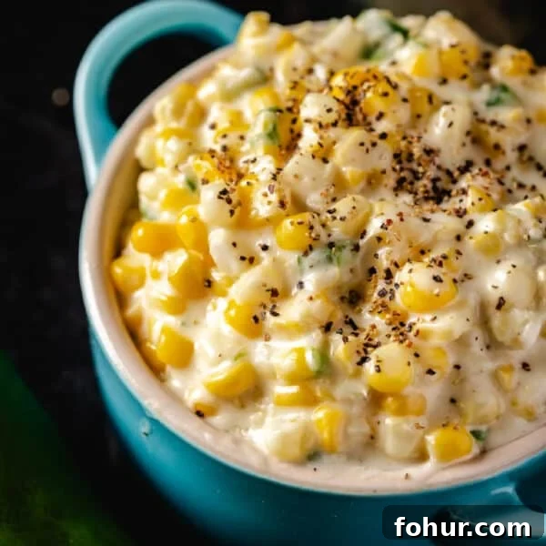 Savory Garlic Rice Pilaf with Lemon and Herbs 8 A blue pot filled with smoked jalapeño creamed corn on a black surface.