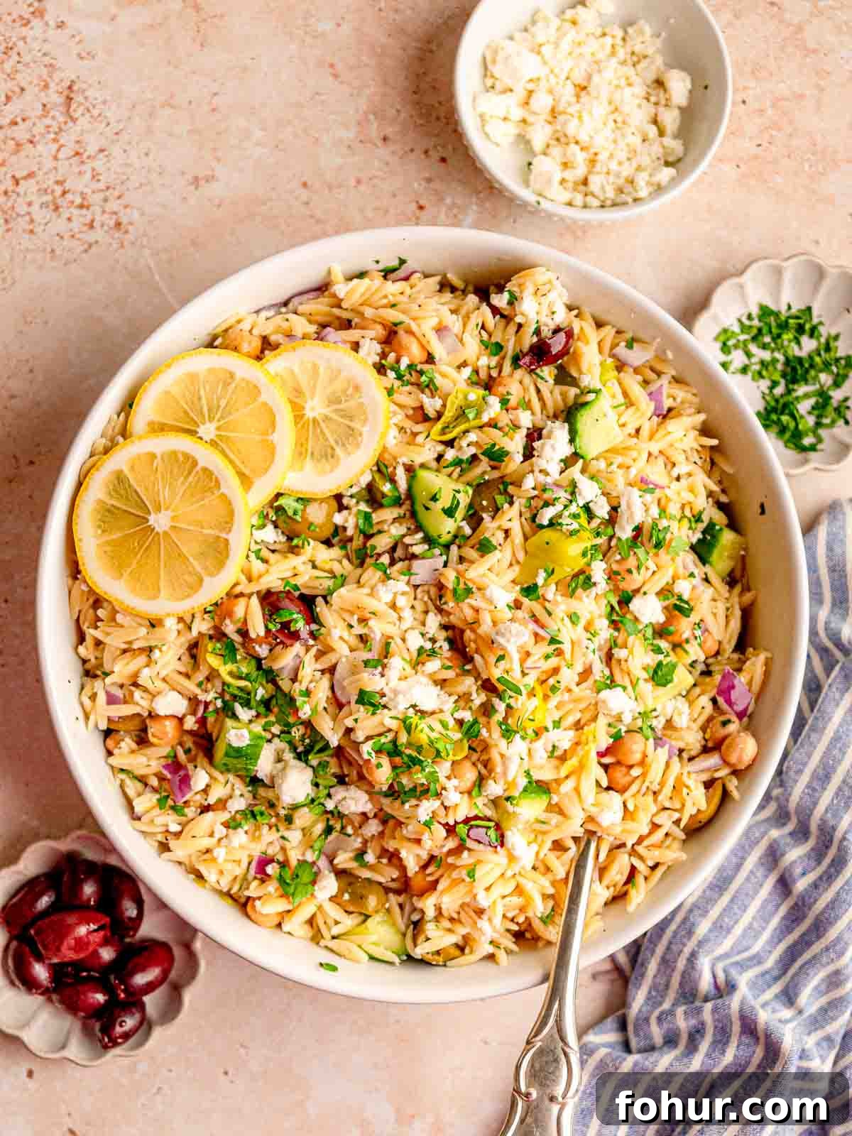 Zesty Lemon Orzo Salad with Feta and Herbs 2 Mediterranean orzo salad in a bowl with a spoon.