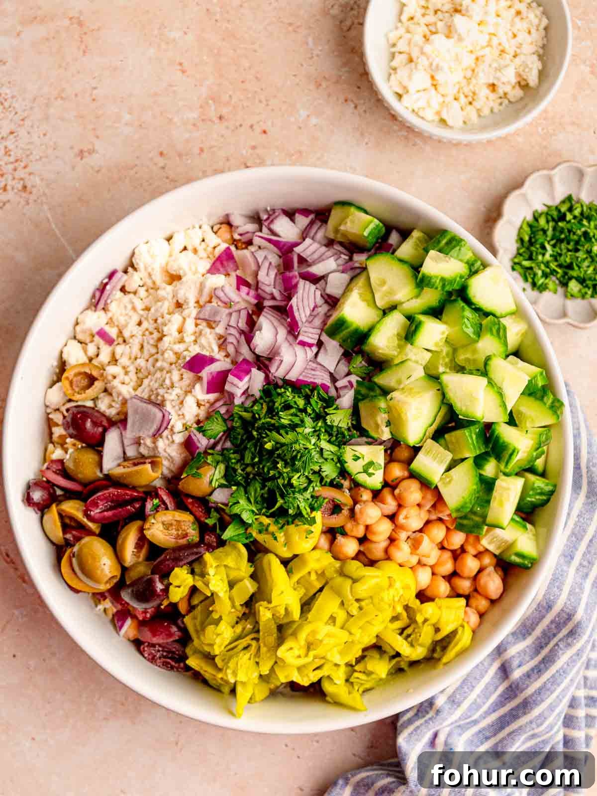 Zesty Lemon Orzo Salad with Feta and Herbs 4 Chopped salad ingredients in a bowl.