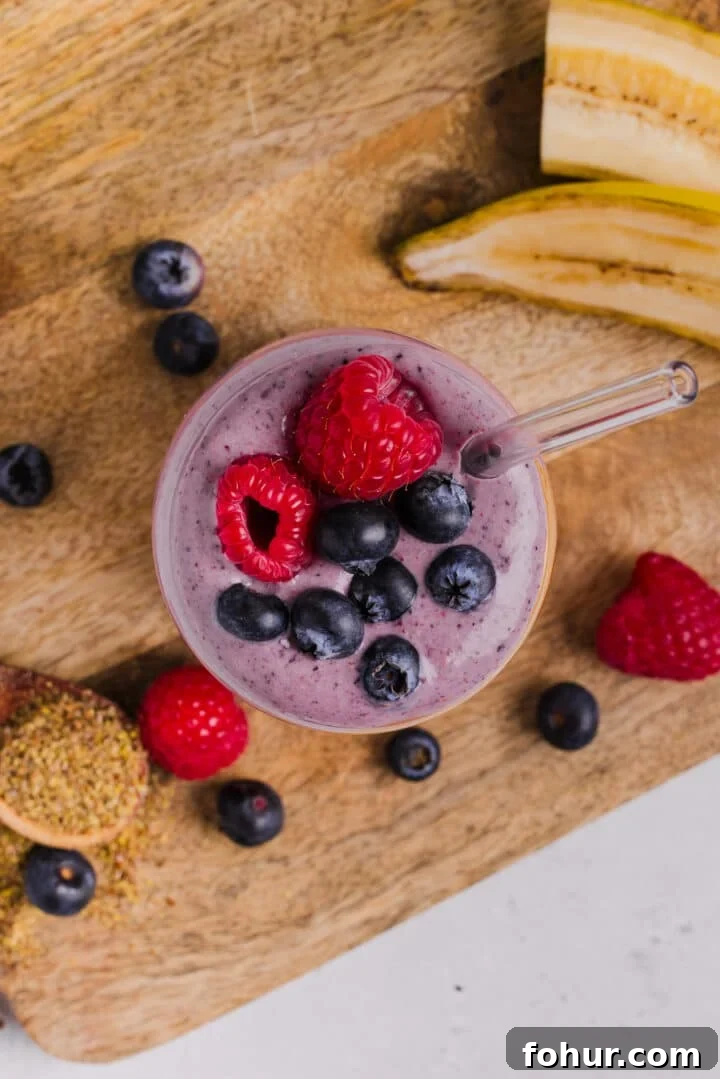 Creamy Peanut Butter and Mixed Berry Smoothie Recipe 5 Overhead photo of a peanut butter berry smoothie in a glass