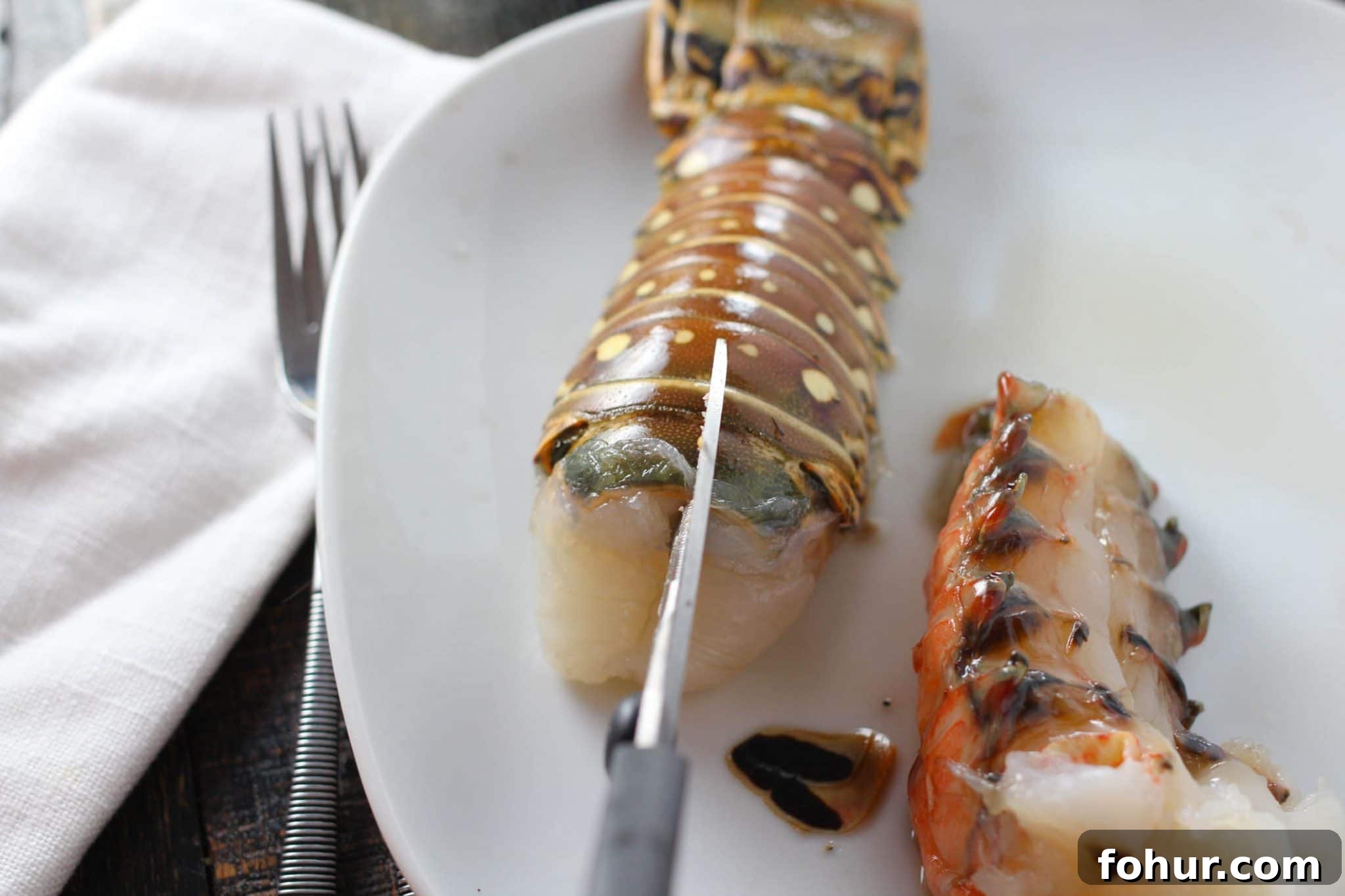 Close-up of saffron butter poached lobster with herbs