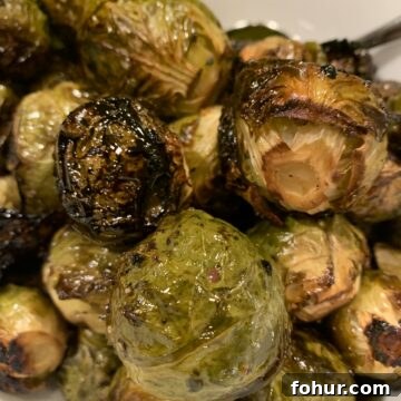 12 St. Patrick's Day Recipes to Make This Year 9 Maple and balsamic drenched Brussel sprouts mounded on a serving plate.
