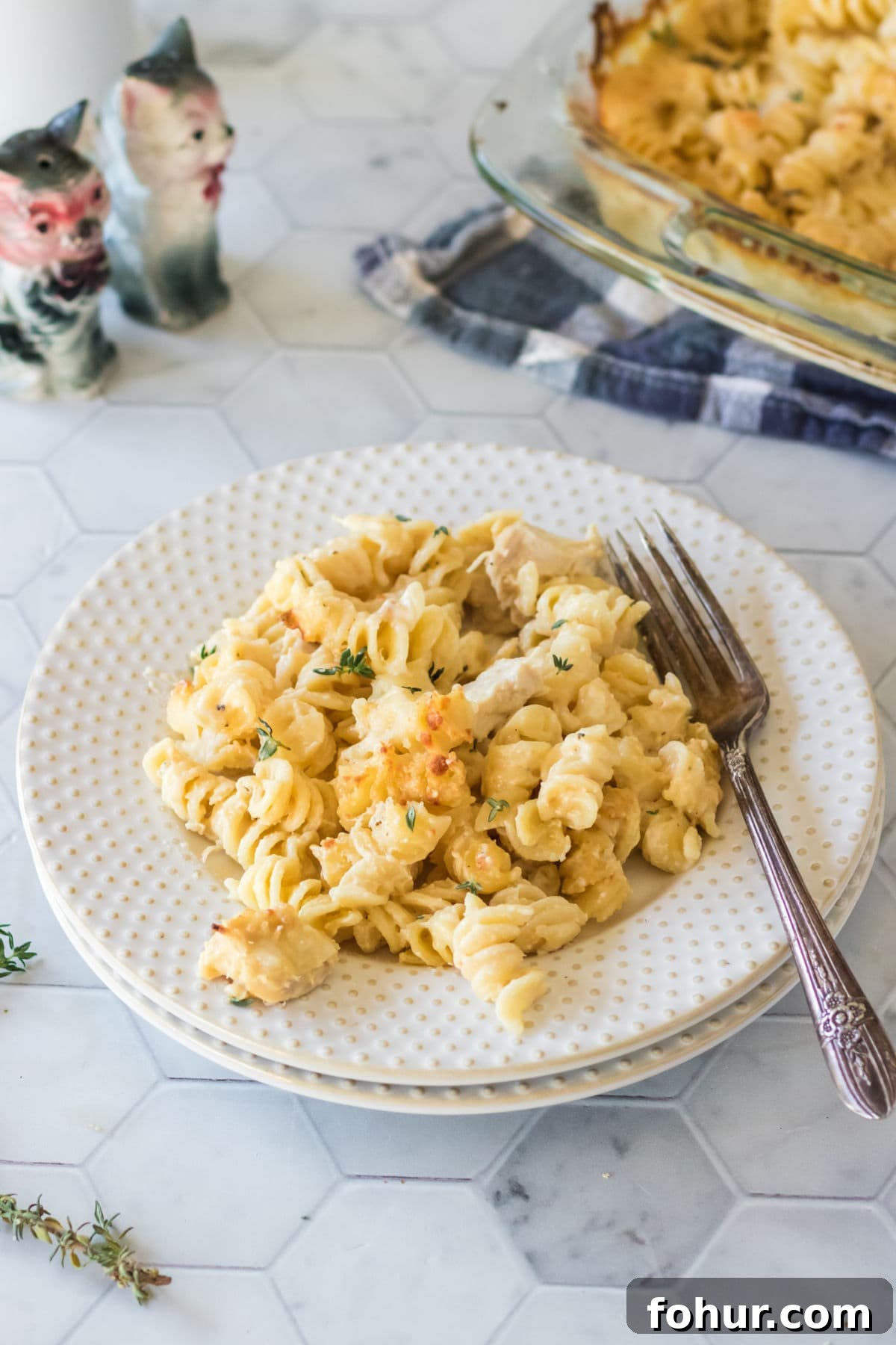 Zesty Chicken Mac and Cheese Recipe 5 Angel Chicken Mac & Cheese on a white plate with a fork.
