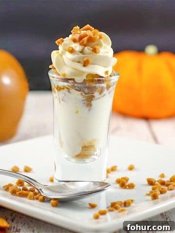 caramel apple betty dessert shot on a white plate with a caramel apple and small pumpkin in the background