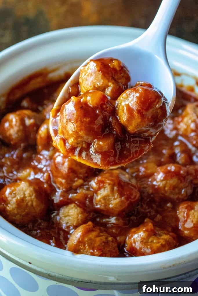 Slow Cooker Spicy Hawaiian Meatballs with Sweet Pineapple Glaze 7 Slow Cooker Spicy Hawaiian Meatballs on a spoon