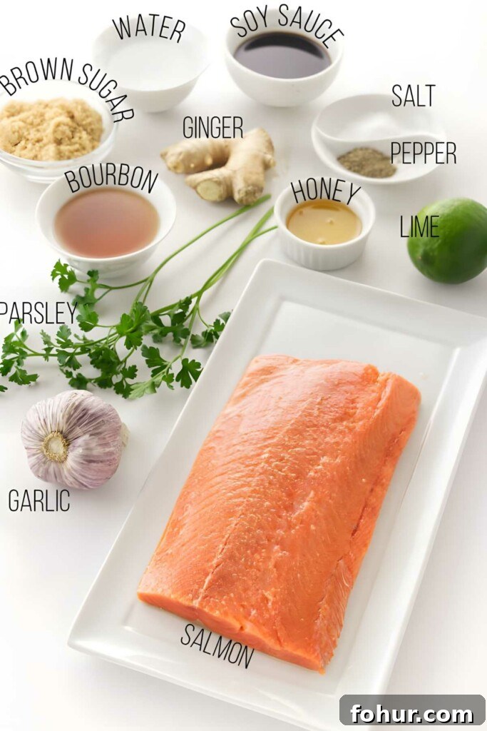 Bourbon Glazed Salmon Fillet Recipe 2 Raw salmon fillet with labeled seasoning ingredients arranged on a white surface.