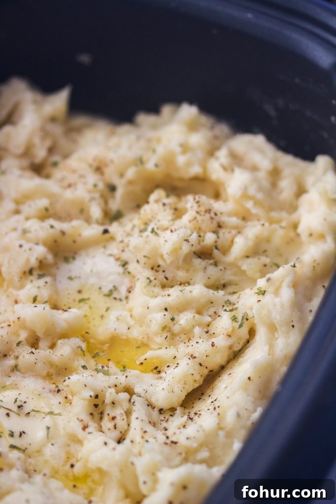 Creamy Slow Cooker Mashed Potatoes 2 Bowl of creamy slow cooker mashed potatoes topped with butter