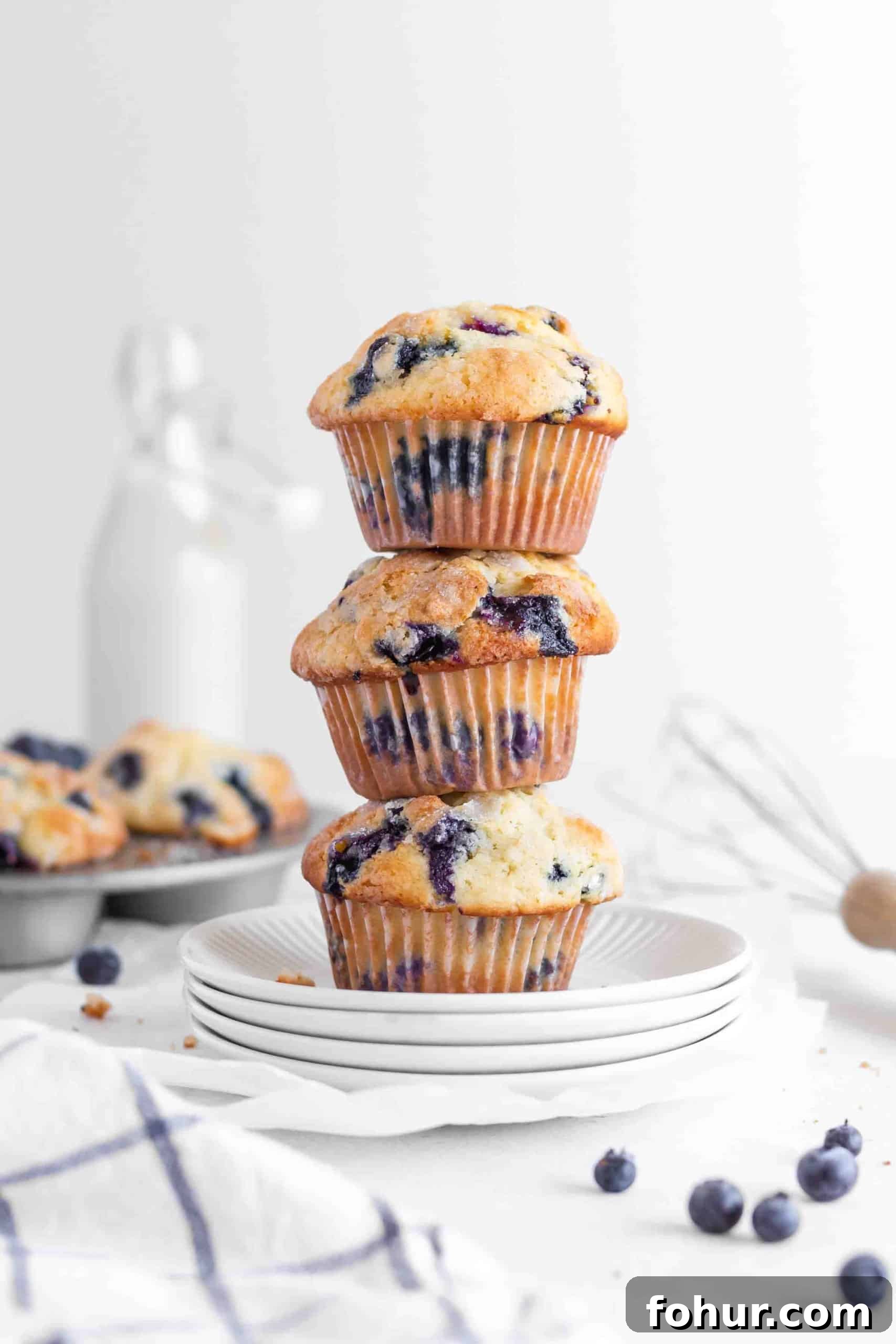 Classic Blueberry Muffins Recipe with Fresh Berries 6 Blueberry muffins stacked on a plate