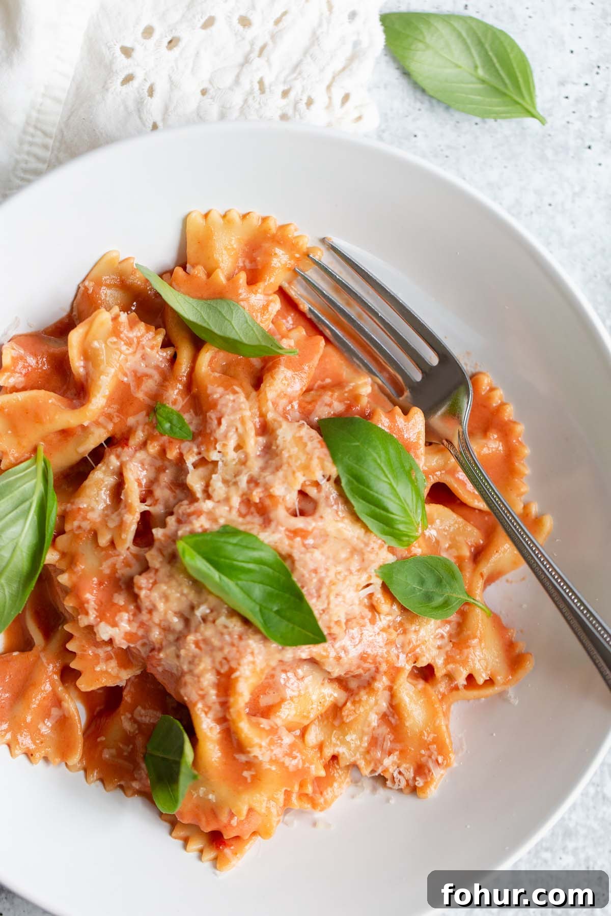 Creamy Harissa Pasta Recipe 3 creamy harissa pasta topped with fresh basil leaves