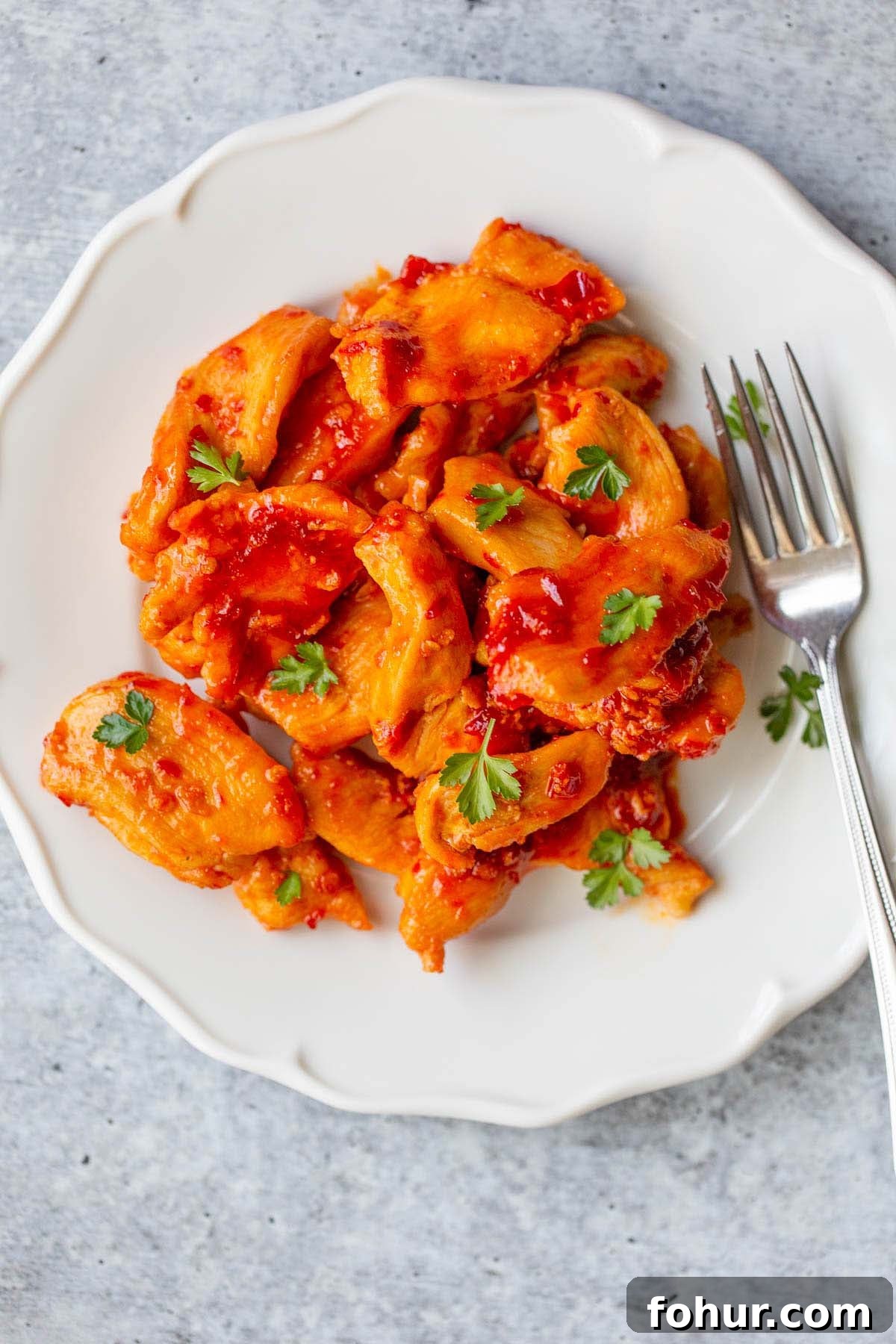 Creamy Harissa Pasta Recipe 5 Harissa chicken on a plate with a fork.
