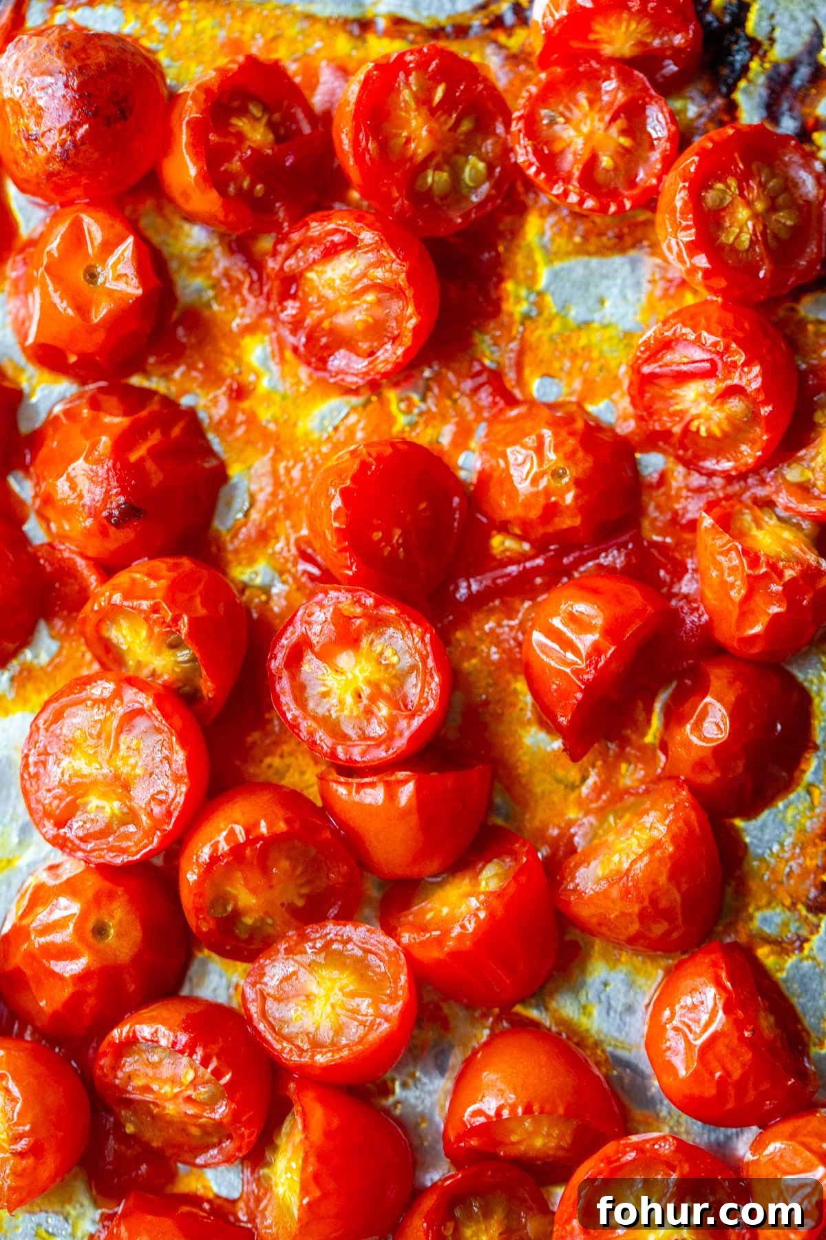 Creamy Harissa Pasta Recipe 6 Roasted cherry tomatoes on a baking sheet.