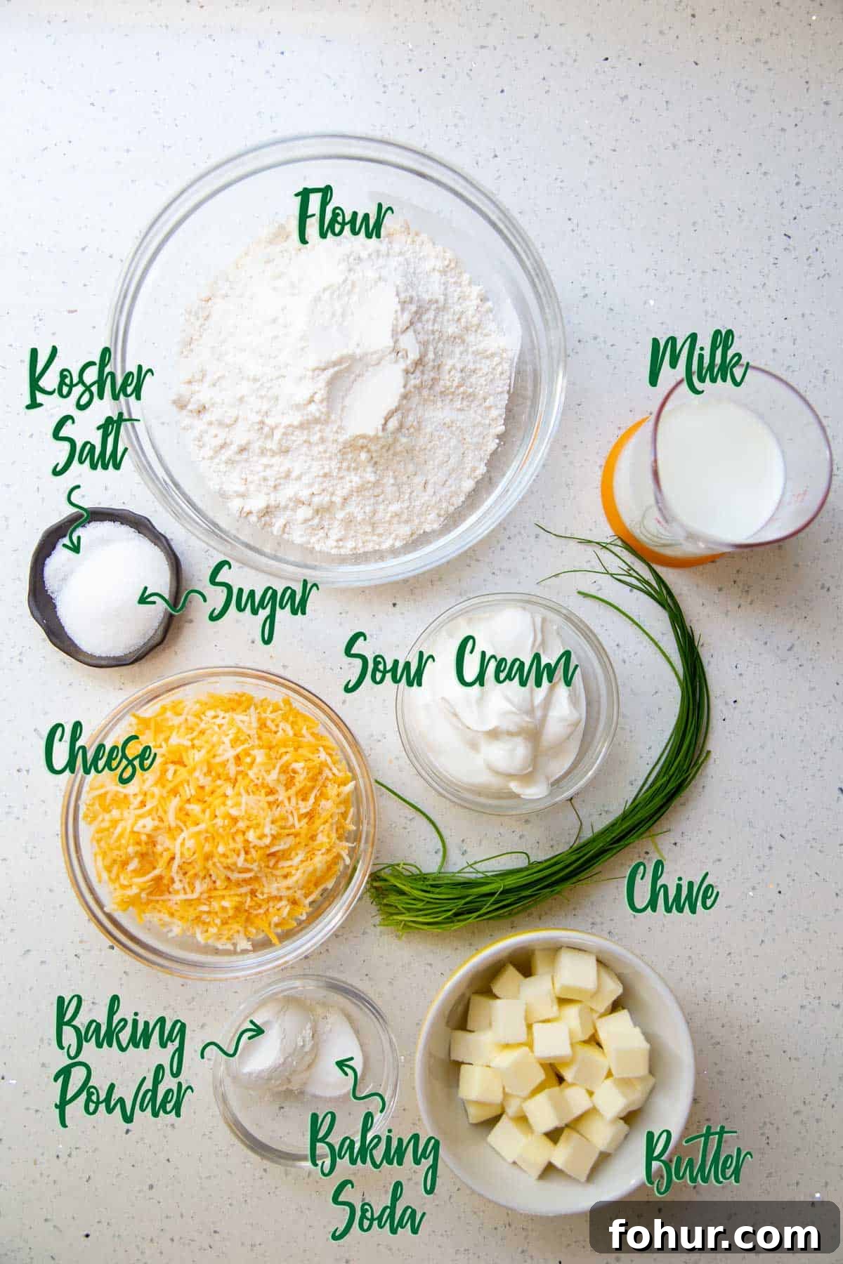 Flaky and Fluffy Cheese Biscuits with Chives Ingredients for cheese biscuits on a white countertop.