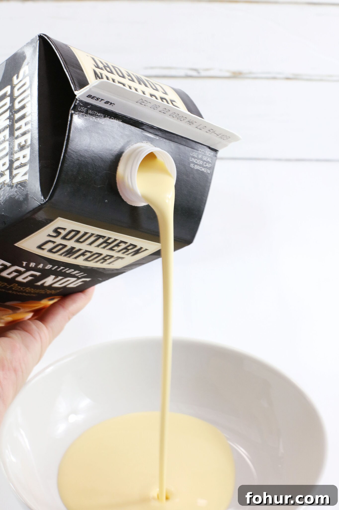 Creamy Eggnog Pudding Shots for Holiday Parties 4 hand pouring eggnog into bowl