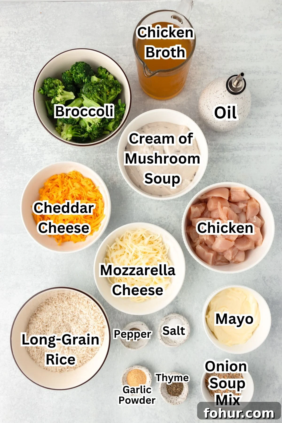 Creamy Cheesy Chicken Broccoli and Rice Casserole 3 A top view of labeled ingredients in bowls for a Cheesy Chicken Broccoli and Rice Casserole: broccoli, chicken broth, oil, cream of mushroom soup, chicken, cheddar cheese, mozzarella cheese, long-grain rice, mayo, onion soup mix, and seasonings.