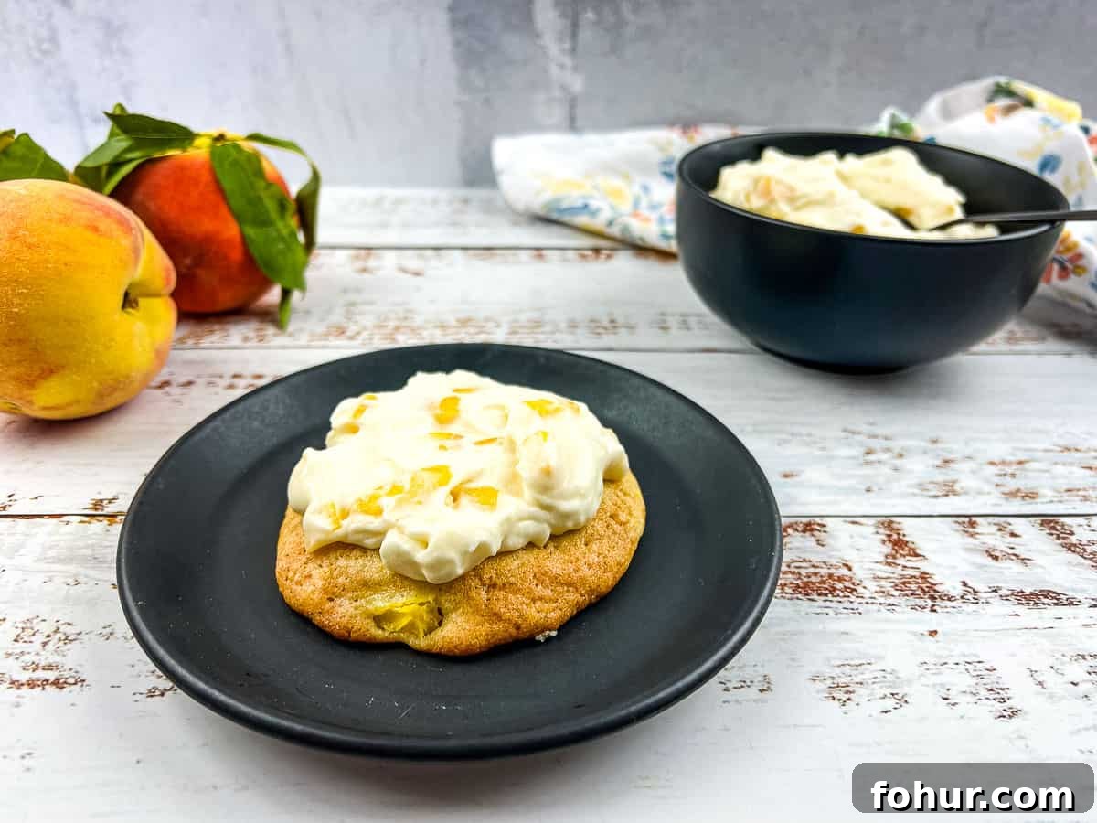19 Cookie Recipes Even Dessert Skeptics Can't Resist 16 Peaches and cream cookies on a plate with fresh peaches nearby.