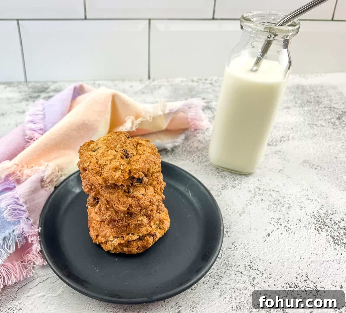 19 Cookie Recipes Even Dessert Skeptics Can't Resist 20 Oatmeal raisin cookies on a plate next to a glass of milk.