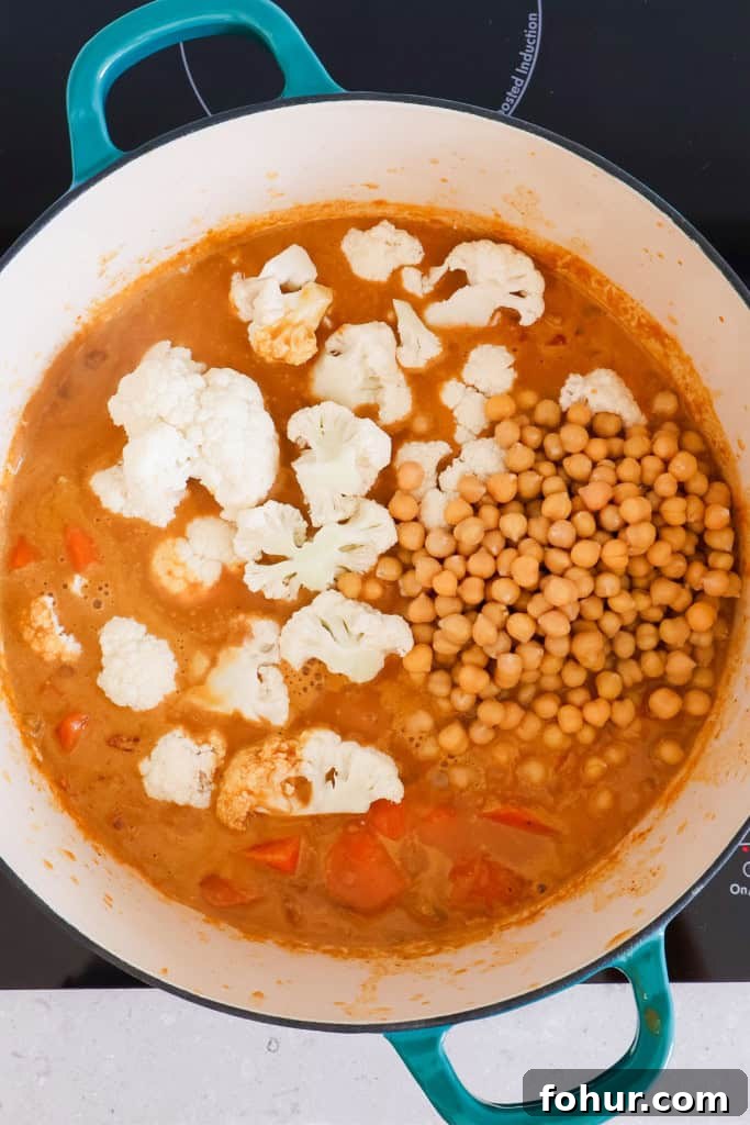Chickpea and Lentil Curry with Warm Spices 7 Cauliflower florets and chickpeas added to the pot.