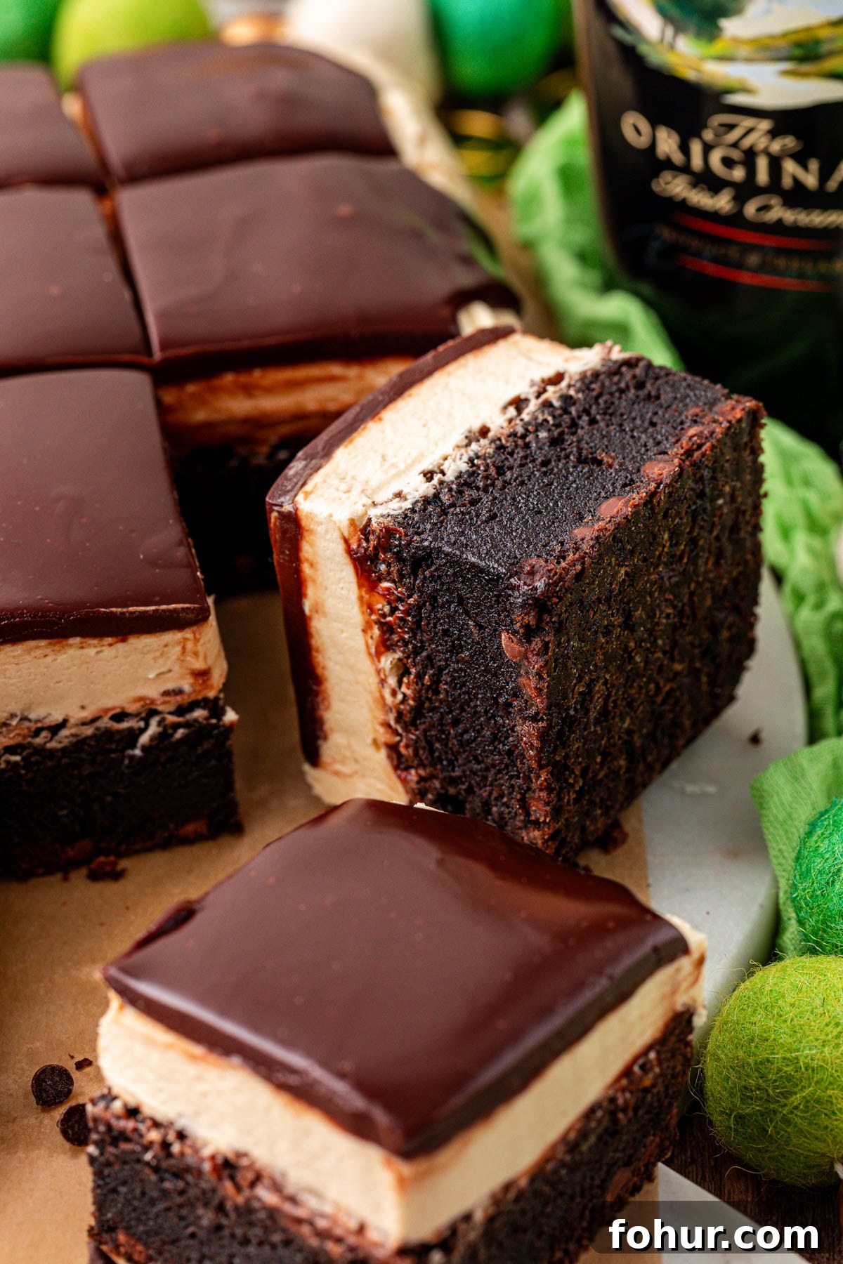 Decadent Baileys Irish Cream Brownies Recipe 2 Close up of brownies with irish cream frosting and ganache.