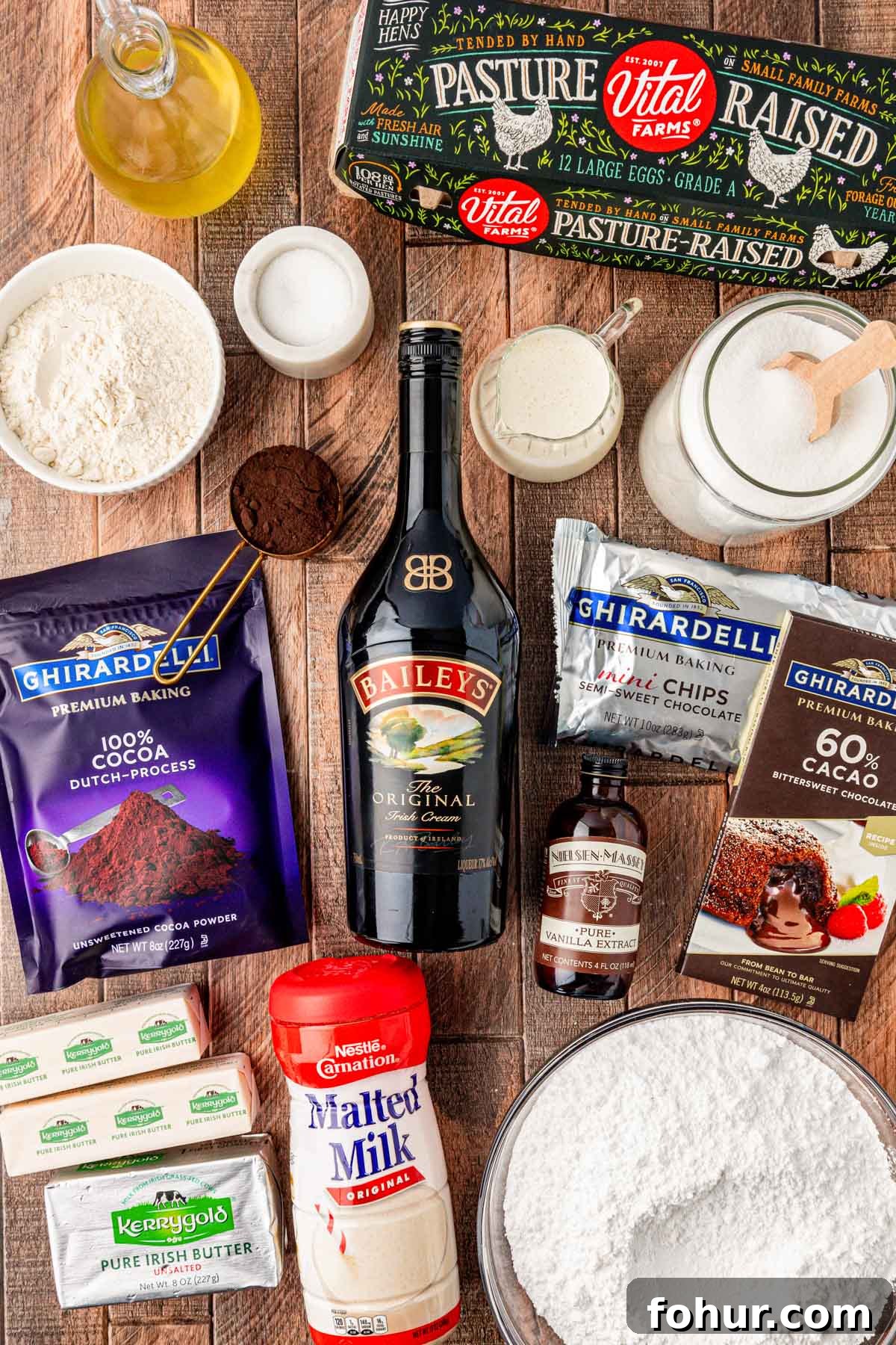 Decadent Baileys Irish Cream Brownies Recipe 3 Overhead photo of ingredients to make Bailey's Irish Cream Brownies on a wooden table.