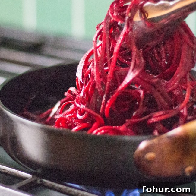 Spiralized Beet Noodle Salad with Creamy Whipped Feta 2 Cooking beet pasta noodles in a skillet.